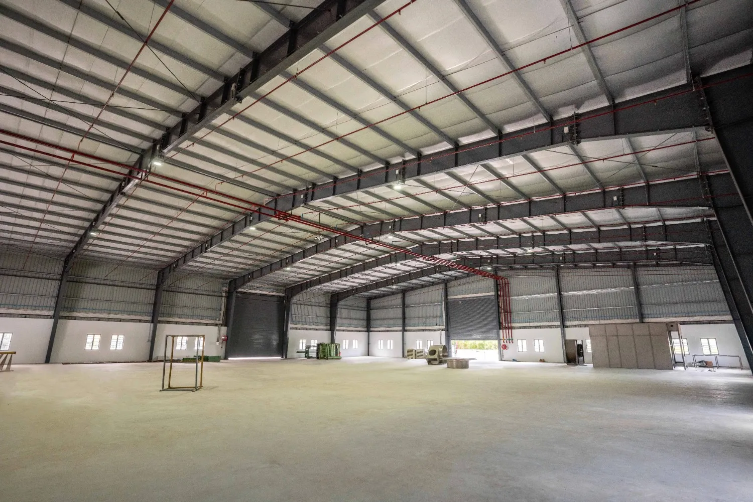 A large industrial Pre-Engineered Building (PEB) roof structure in Coimbatore, showcasing robust steel trusses, durable metal sheeting, and clean architectural design suitable for factories, warehouses, and commercial use.